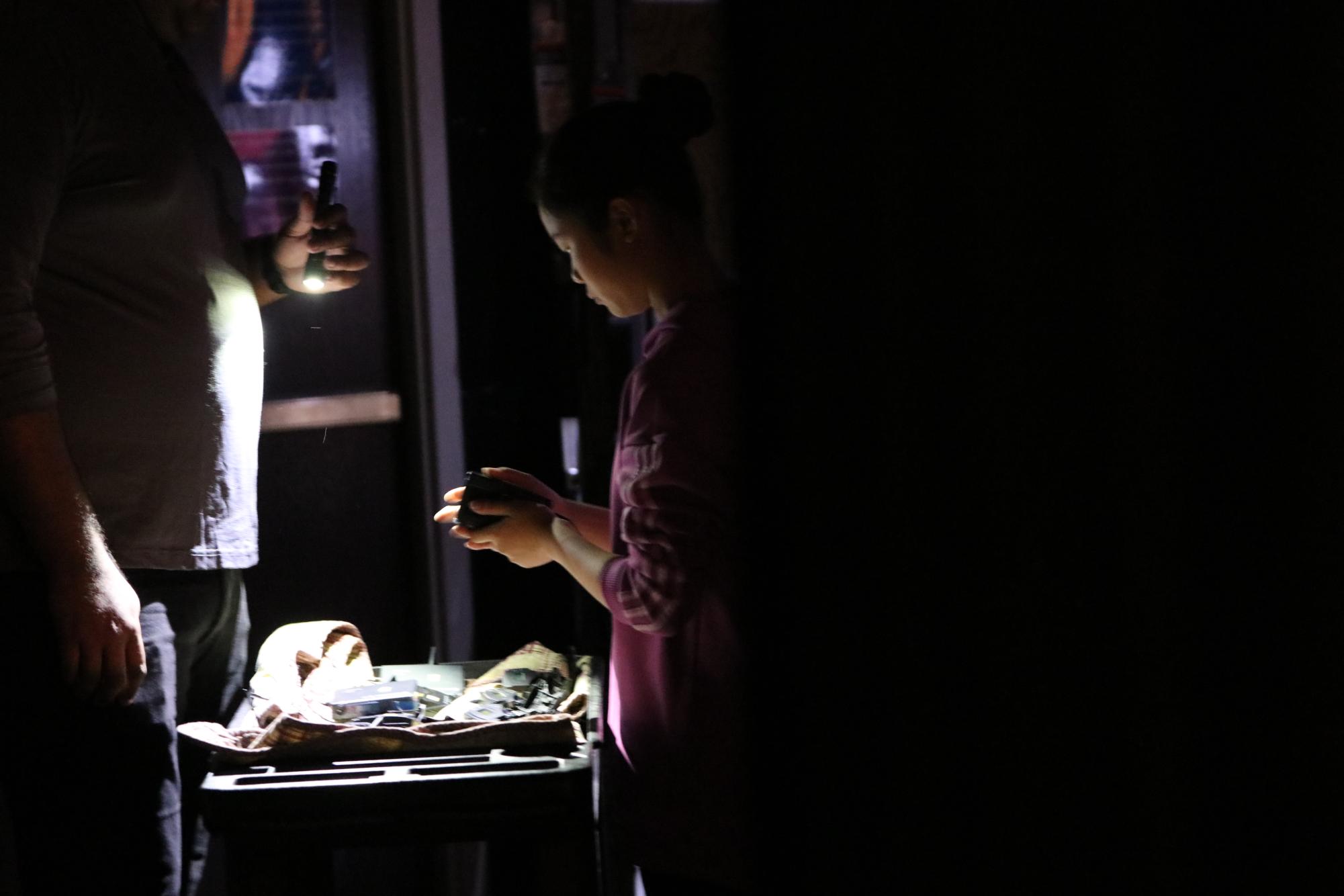 Seventh grader Tess Chen works by flashlight as she will have to do during the night of the show. 