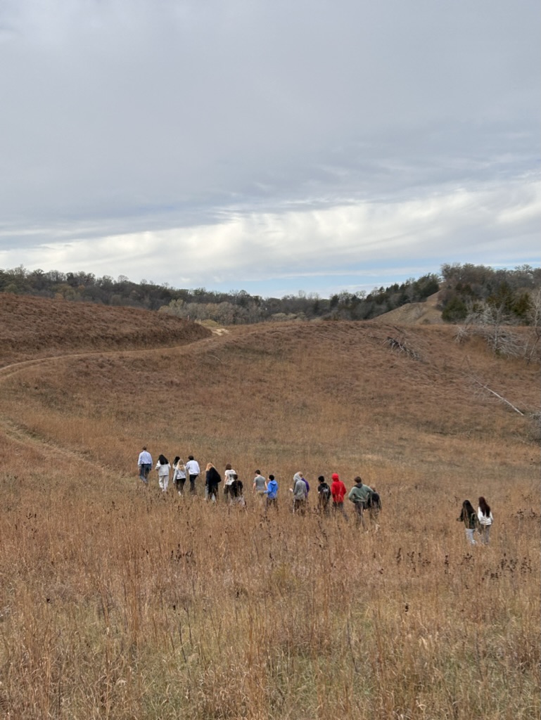 Members of NHS take a tour through remnant and restored prairie in the Loess Hills with Pottawattamie County Conservation Resource Manager Chad Graeve. 