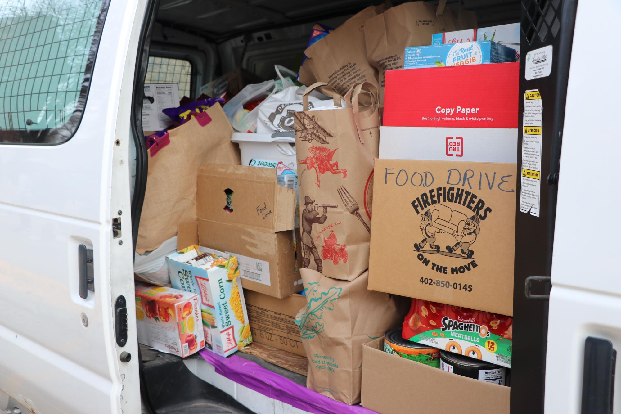 The fall food drive was so successful that donations overflowed from Completely Kids transport van into a second vehicle.