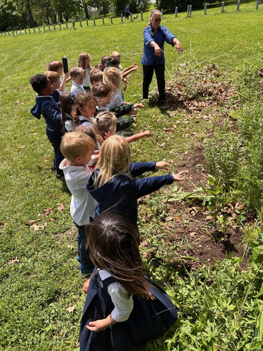 Ms. Gibbins and her students do a post-planting ritual to encourage the plants to grow.