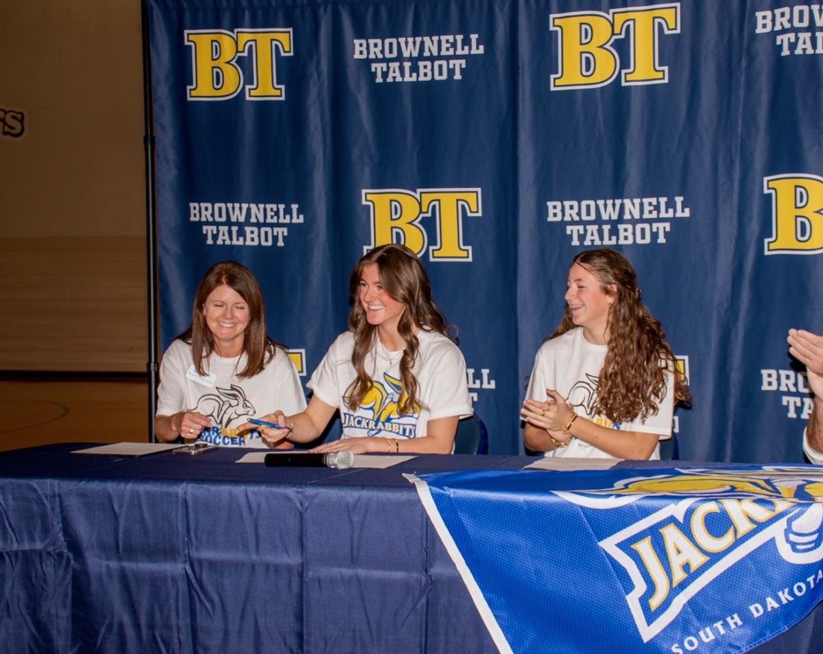 Abbi signing her commitment paper.