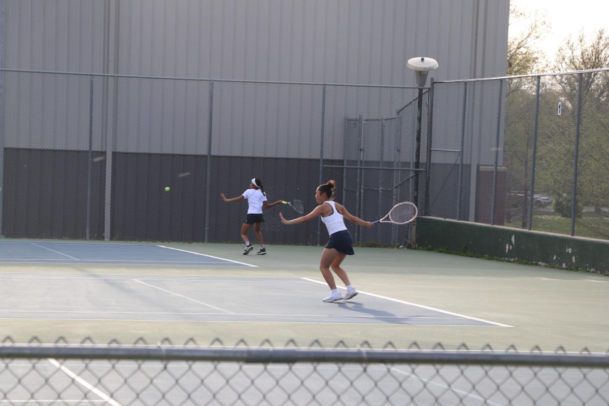 Tess Chen and Reeya Chundury synchronize forehands at Woods Tennis Center in Lincoln, NE. 